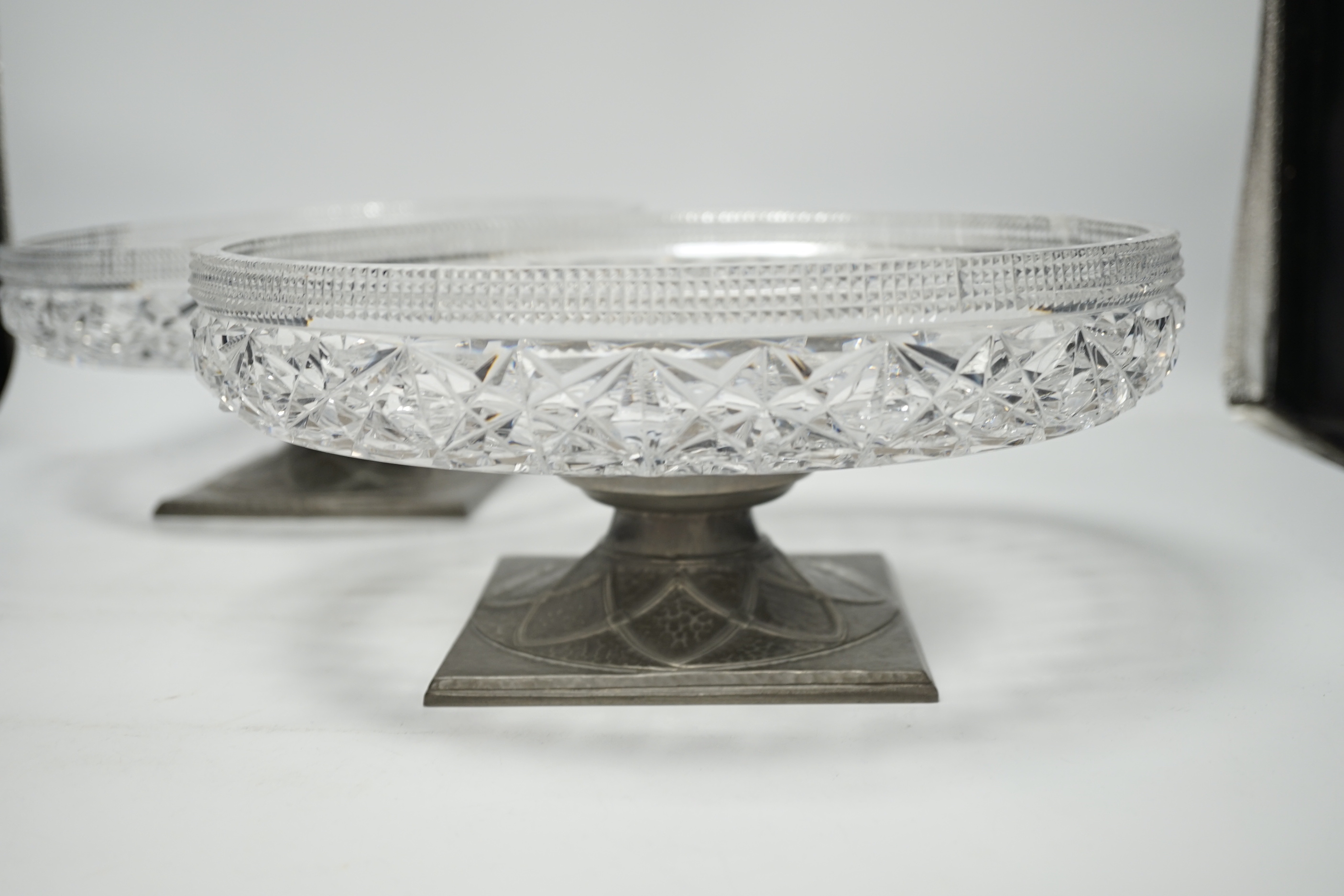 A pair of Tudric pewter based tazza with cut glass bowls, bowls 28cm diameter